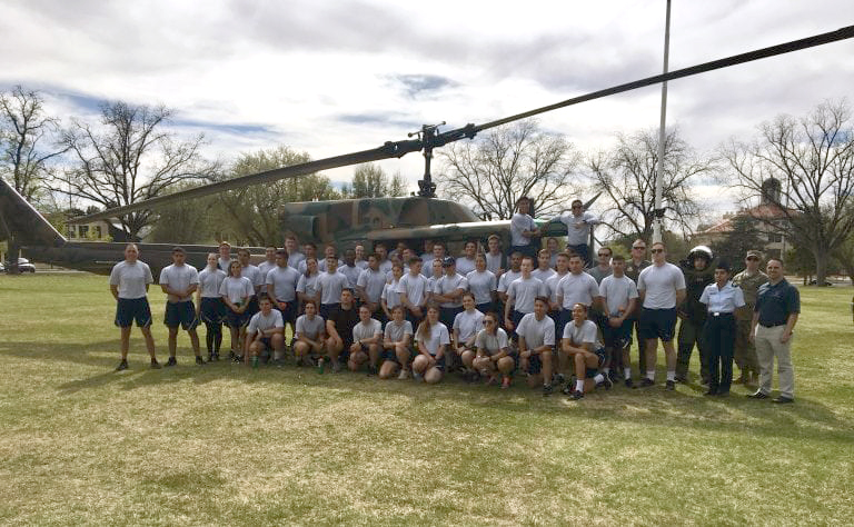 Cadets at “A&M Day” in front of a UH-1N helicopter on NMSU’s Hadley Field